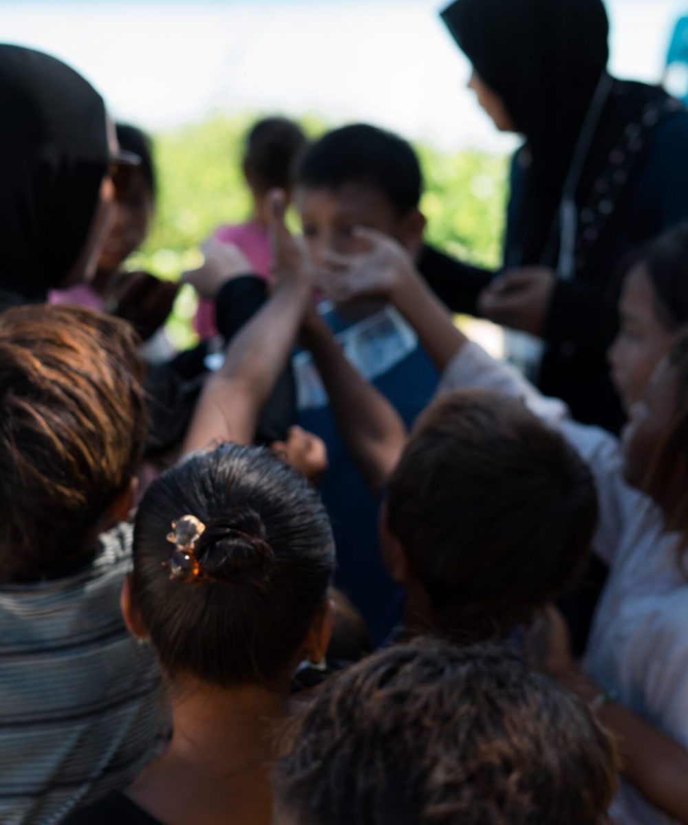 Sibuan, Malaysia - November 26, 2019: Visitors distributing snacks and goods to the Bajau Laut kids in their village.